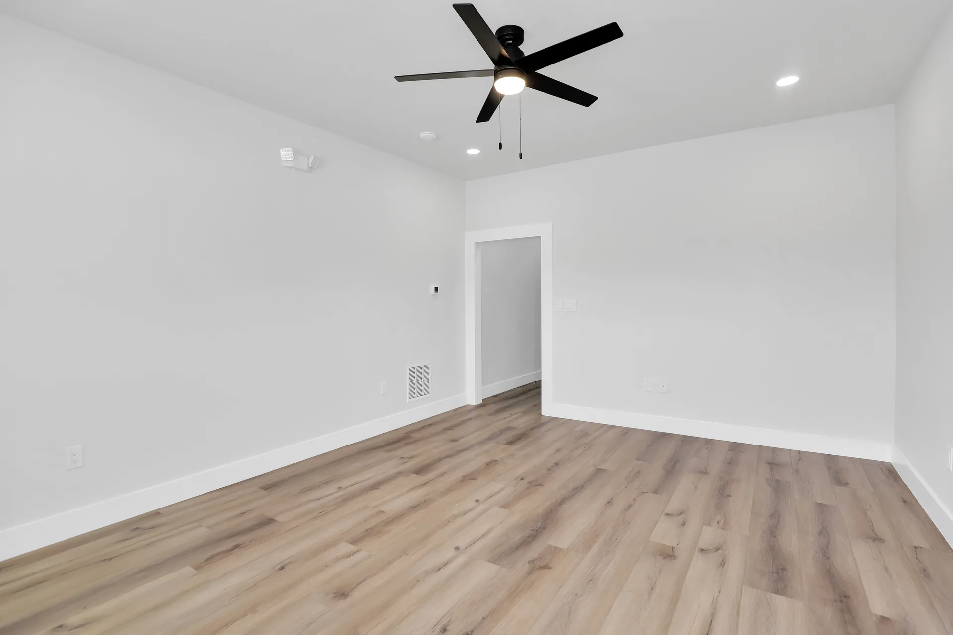 Finished office interior at Triple C Business Park with white walls, wood-look flooring, recessed lighting, and ceiling fan
